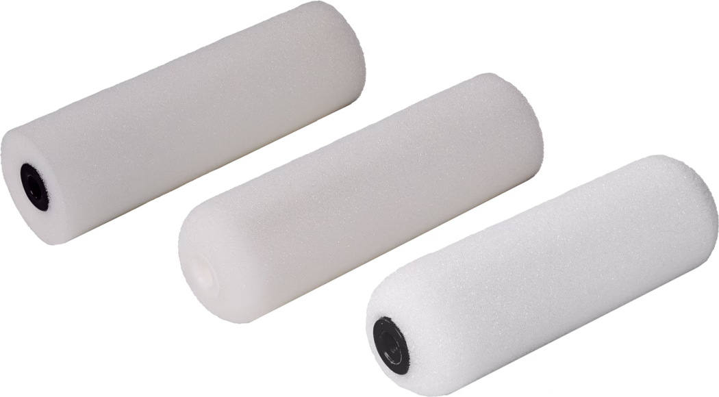 Pajarito_Dummy_Small roller Foam Easy Line_168967_168968_168969_168970_2021-11 Drei weiße Schaumstoff-Farbwalzenbezüge diagonal auf weißem Hintergrund angeordnet. Jeder Bezug ist zylindrisch mit feiner offenporiger Schaumstruktur; zwei besitzen schwarze Kunststoff-Endkappen, einer eine weiße Endkappe. Die Walzen sind freigestellt fotografiert und eignen sich für kleine Lackier- und Finish-Arbeiten; das weiche, gleichmäßige Licht betont die poröse Oberfläche, die feine Struktur und dezente Schatten.